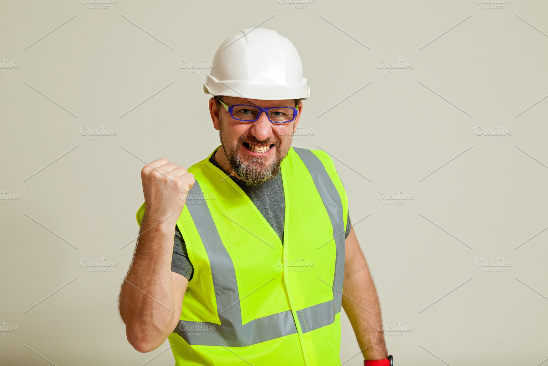 worker in a vest and white helmet, a Person Photo by Photostock