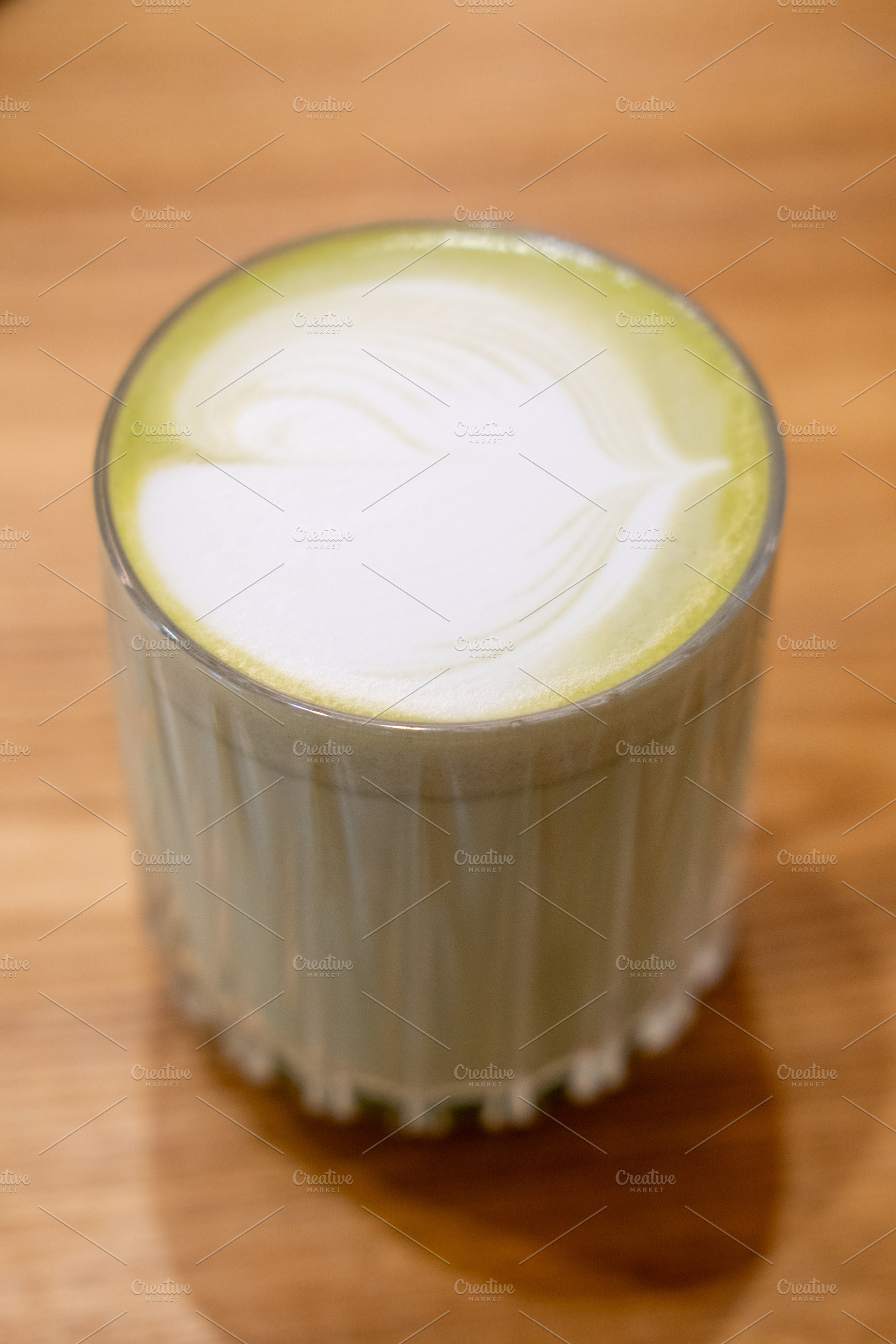 Matcha latte healthy beverage glass cream green, a Food & Drink Photo by Photo Drive Studio