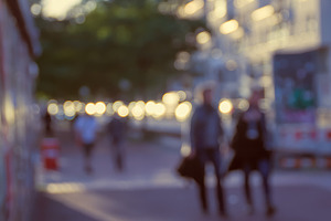 Blurred street featuring city, people, and street