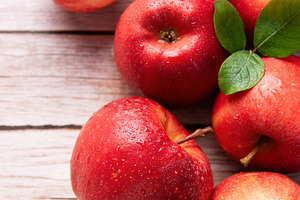 Fresh red apples resting on rustic wooden table, a Food & Drink Photo by Olena Rudo