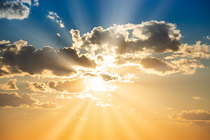 Sunset sky with clouds and sun