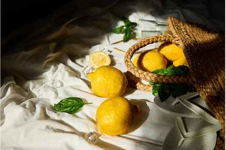 Bright summer lemons in a woven bag