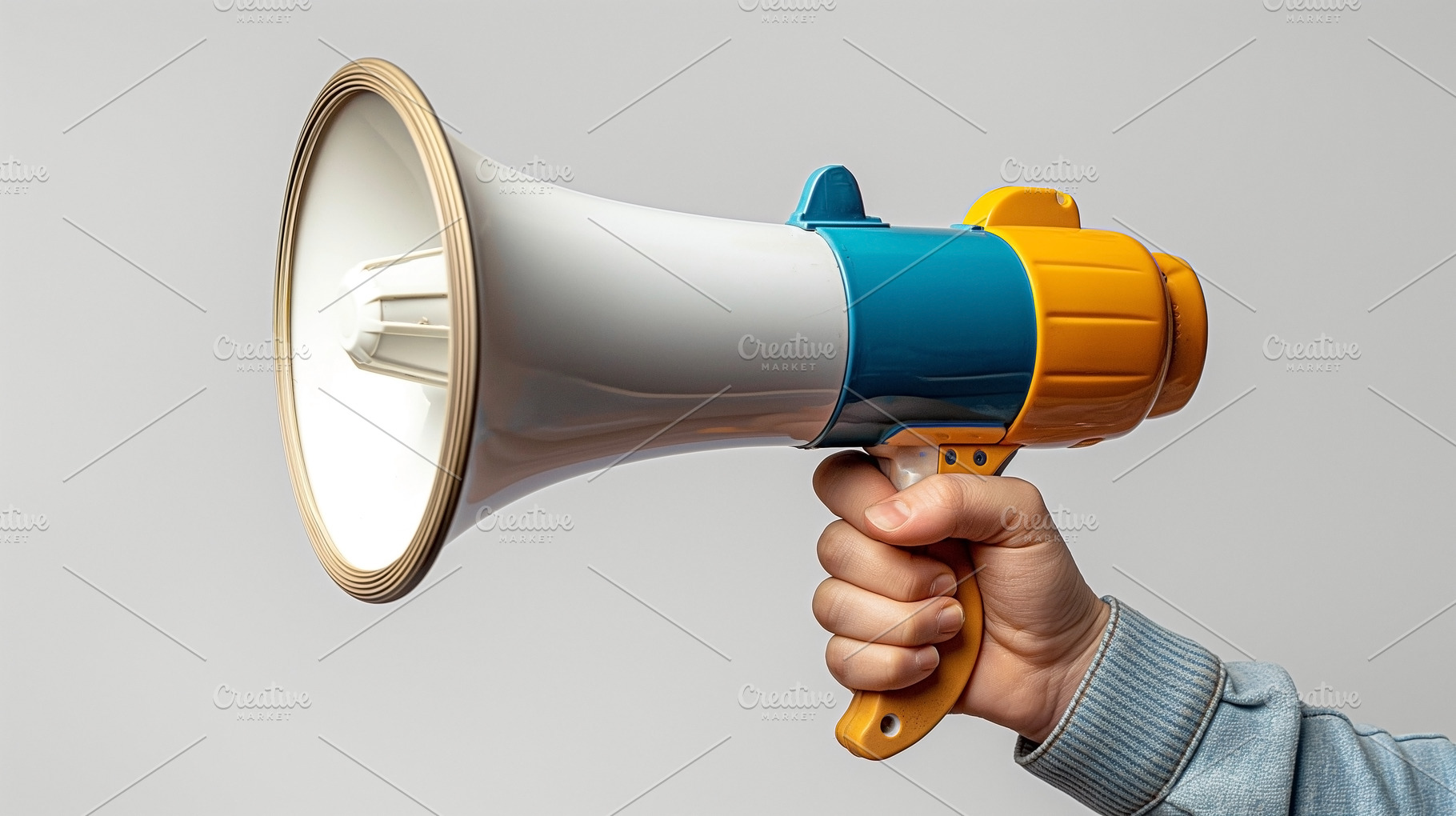 A hand holding a colorful megaphone, ideal for announcements and, a Person Photo by ImageMir