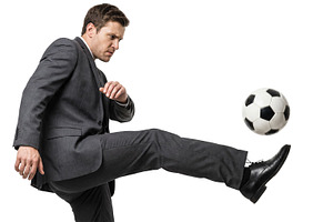 a man kicks a soccer ball, a Person Photo by itakdalee