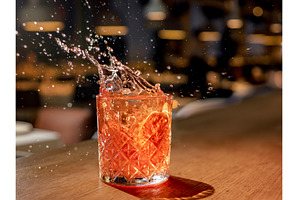 Red brown cocktail with splashes in, a Food & Drink Photo by Fascinadora