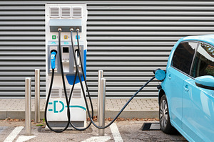 Electric car at charging station, a Transportation Photo by BOOCYS