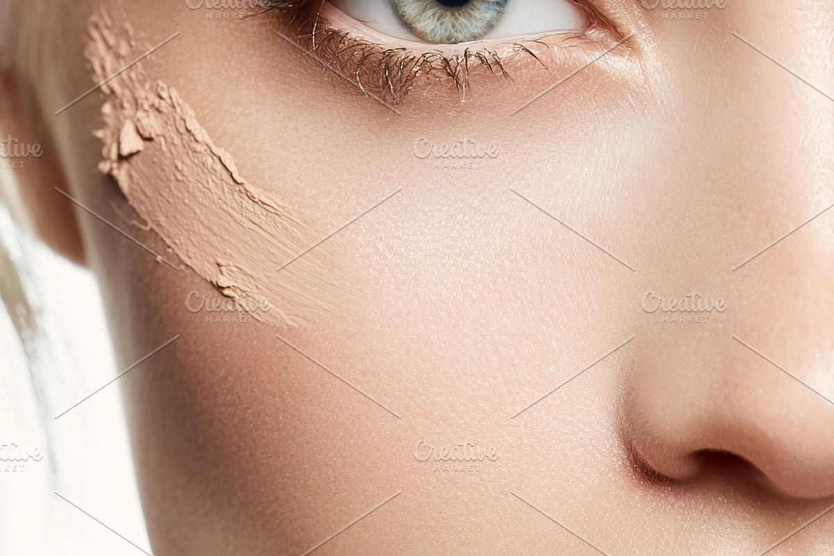 Woman applying makeup foundation on her clean face, preparing fo, a Beauty & Fashion Photo by Studio ANNA (Photo 2 of 2)