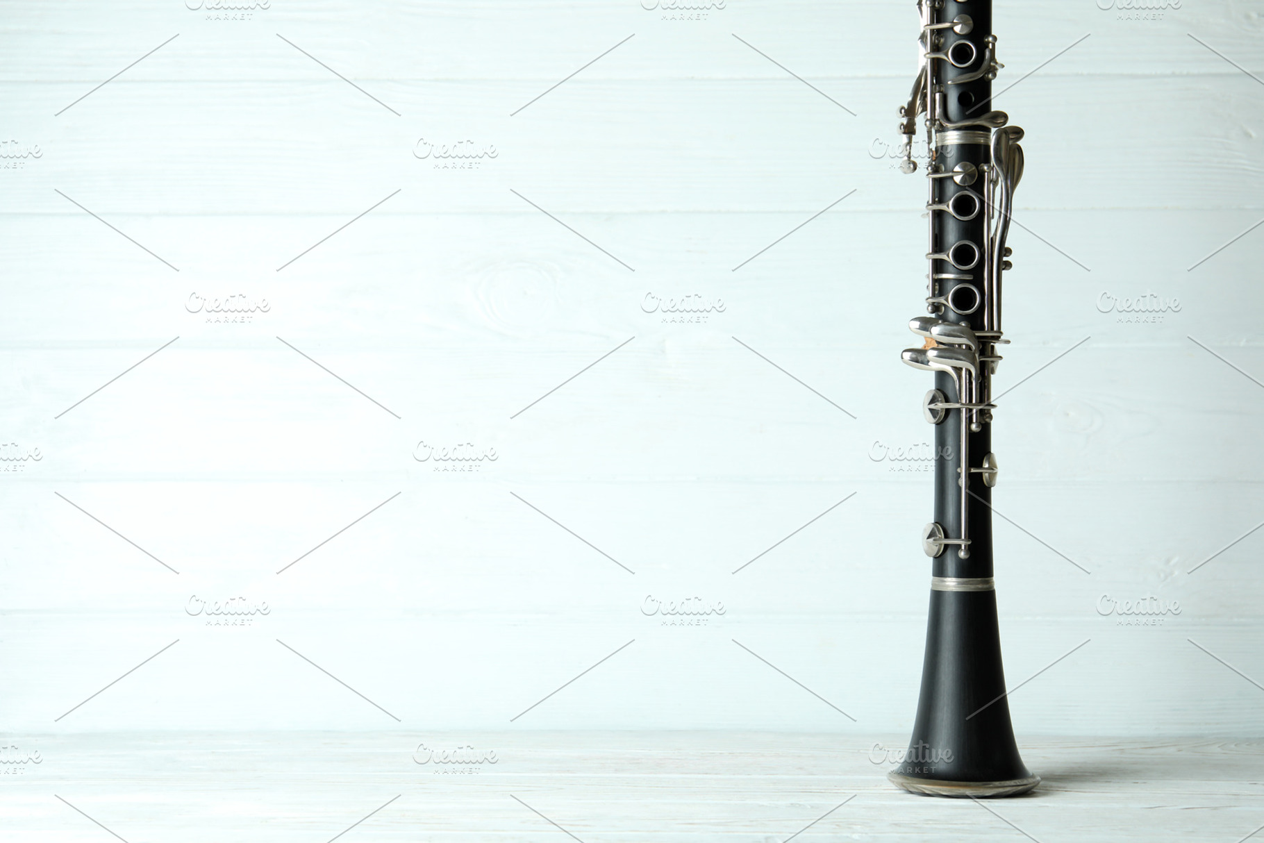 Clarinet on white wooden background, space for text, an Industrial Photo by AtlasStudio PRO