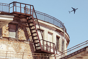 Airplane flying over city, a Transportation Photo by BOOCYS