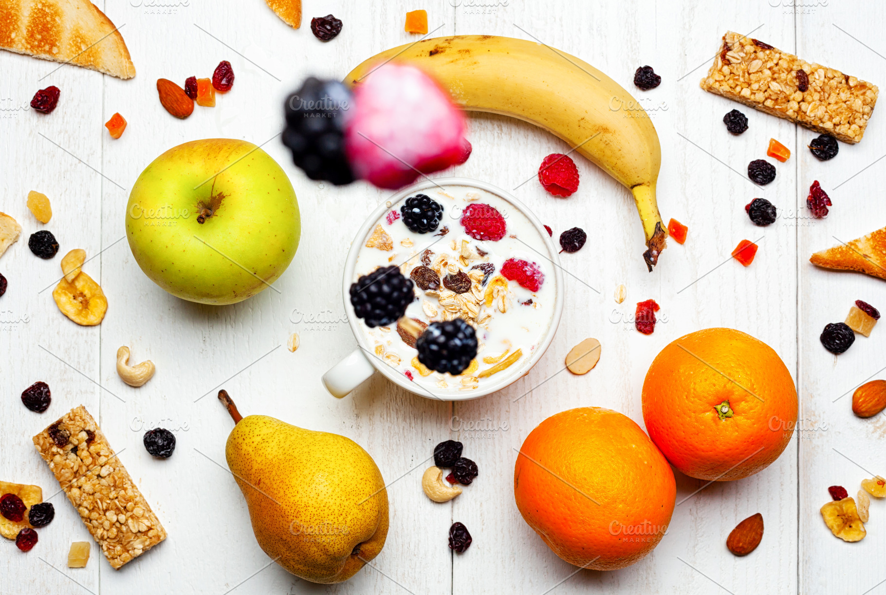 Healthy breakfast with yogurt, muesli, fresh and dried fruit falling in a cup, a Food & Drink Photo by Antonio Gravante Market