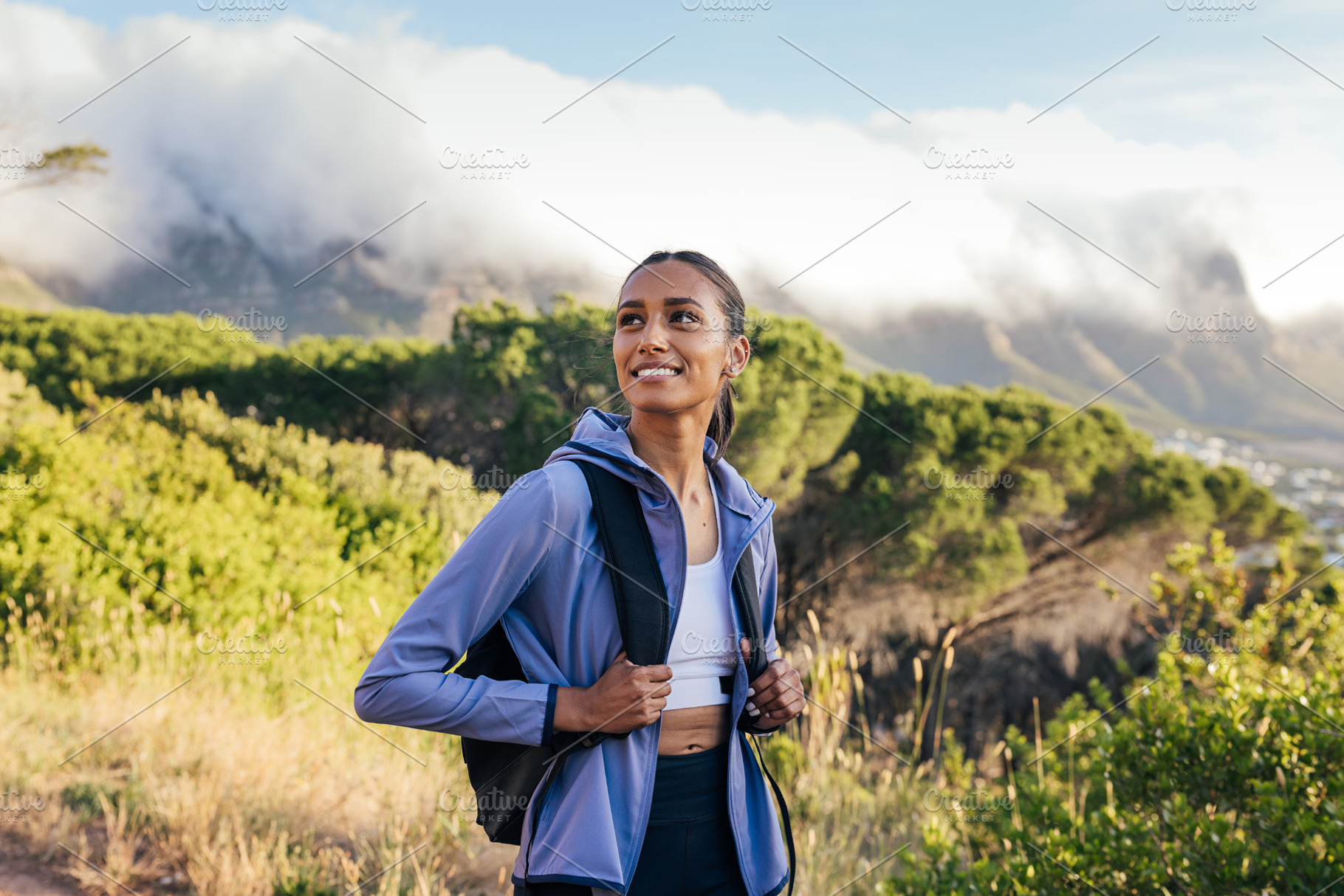 Smiling woman with backpack, a Sports & Recreation Photo by Artem Varnitsin
