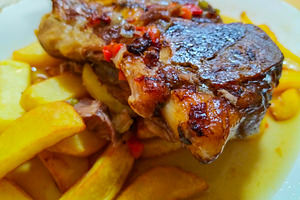 Grilled meats with potatoes on a table, a Food & Drink Photo by DanFLCreativo