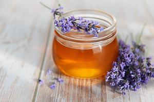 Lavender honey jar with fresh flowers on wood, a Food & Drink Photo by Olena Rudo