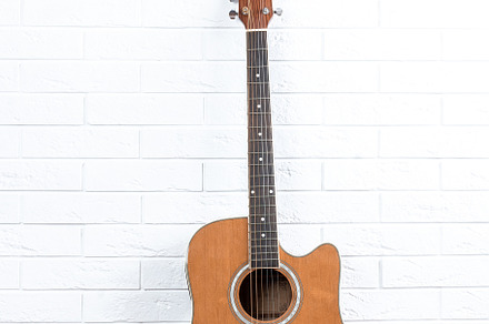 Guitar on a brick wall background, an Arts & Entertainment Photo by AlexBush