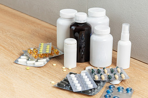 Medicine bottles and blister packs with various pills on wood, a Health & Medical Photo by Olena Rudo