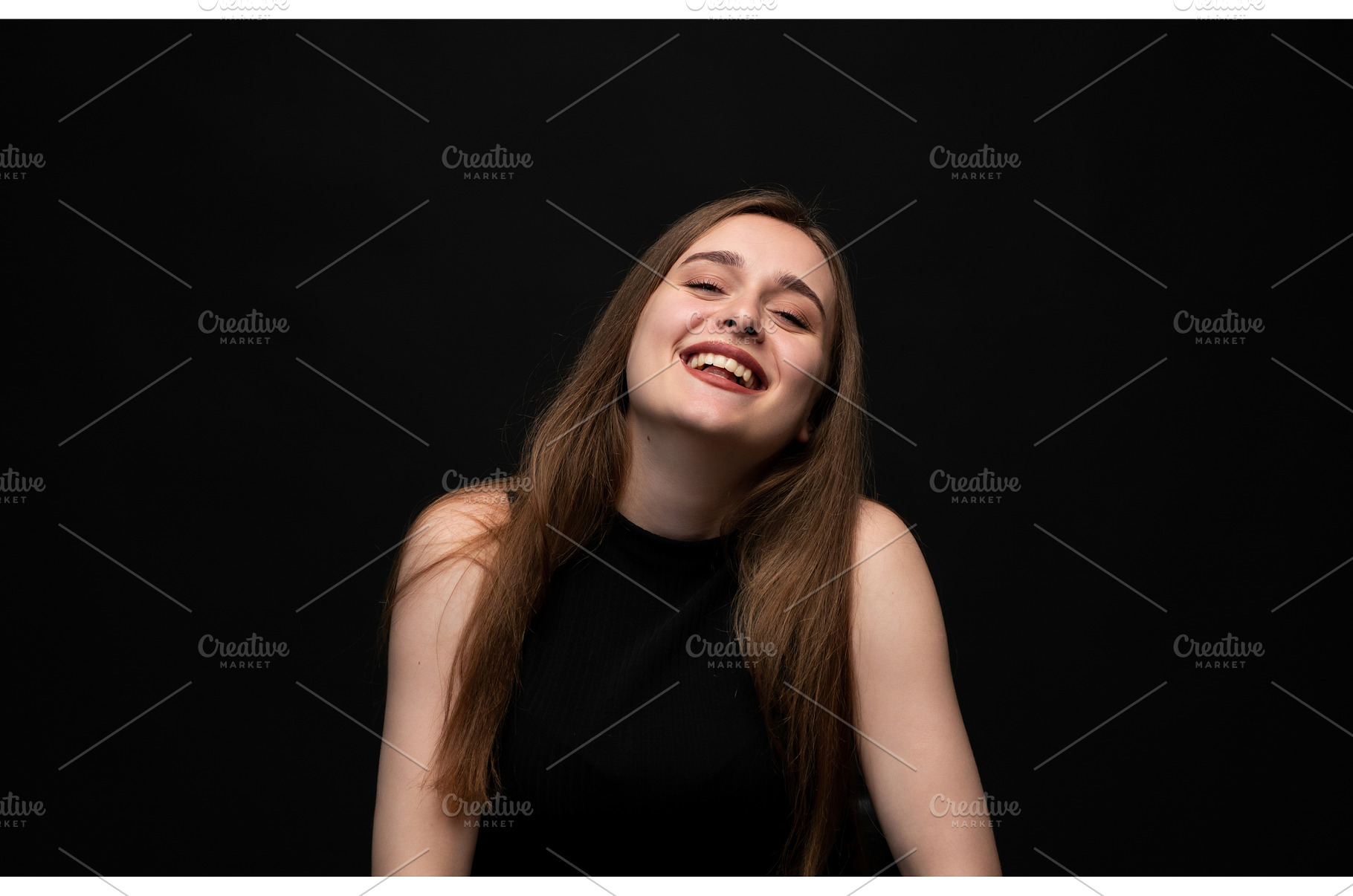 Happy young woman posing on a black, a Person Photo by volodymyrshtun13795