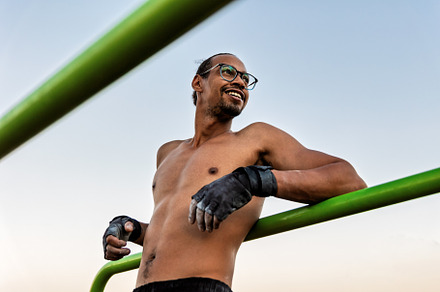 Athlete on a calisthenics bar outdoo