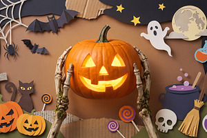 skeleton holding Halloween pumpkin