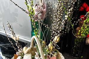 Rustic basket adorned with floral arrangements and natural willow branches, a Photo by AS photostudio
