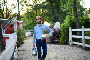 Portrait of farmer holding lavender, a Person Photo by HalfPoint