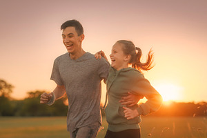 Two young people jogging together at sunset, a Photo by DanFLCreativo