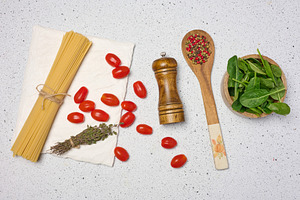 Wooden bowl with spinach, cherry tomatoes on a wooden plate, spo, a Food & Drink Photo by ndanko