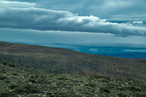 Mountains covered by big clouds at top, chubut province, argenti, a Photo by DanFLCreativo