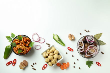 Bowls of marinated mushrooms on white background, a Food & Drink Photo by AtlasStudio PRO