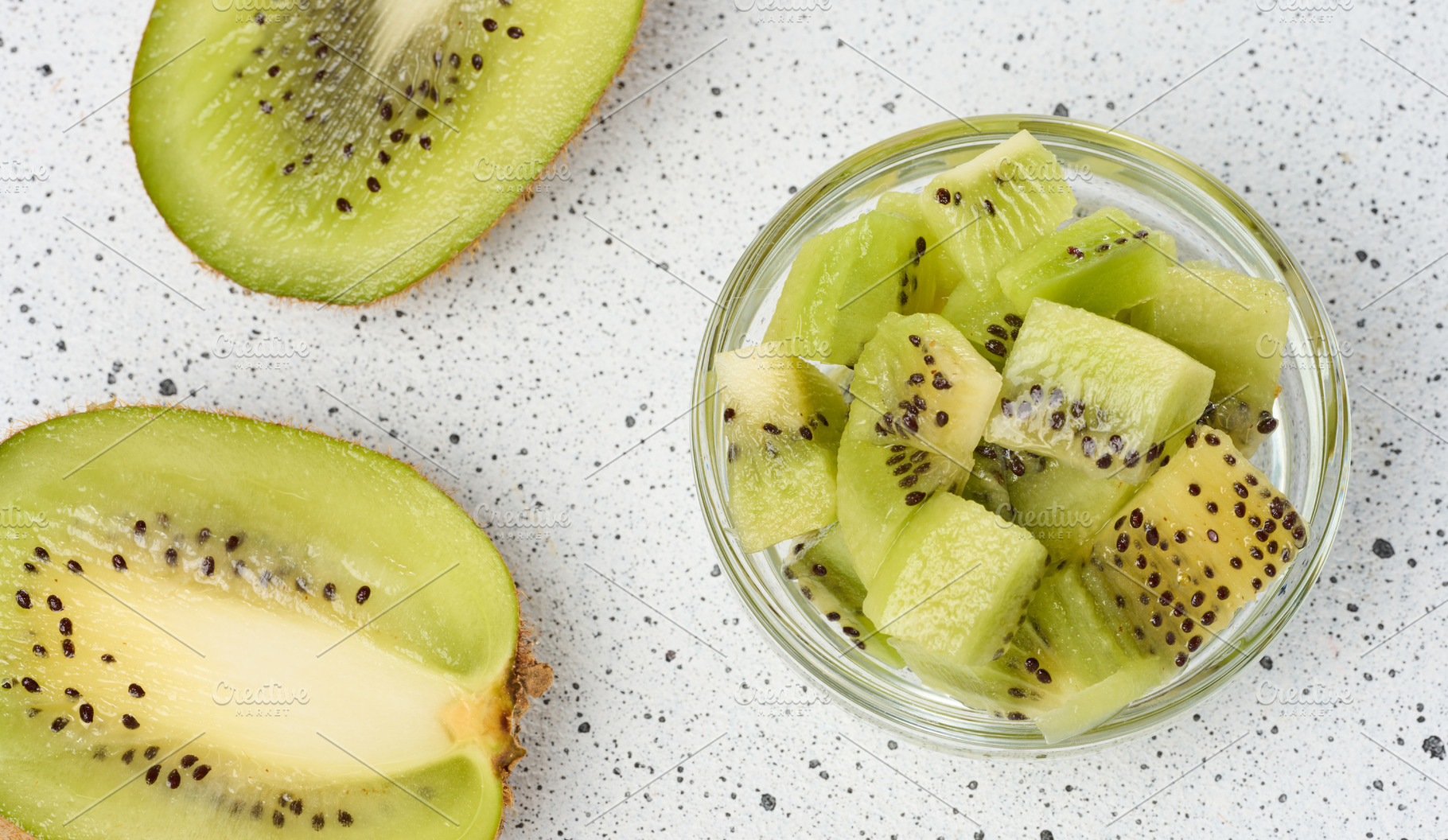 Diced kiwi in glass bowl, top view, a Food & Drink Photo by ndanko