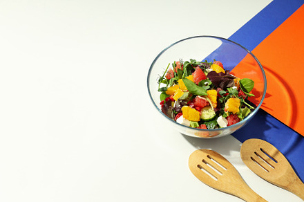 Concept of tasty food, salad with red orange, space for text, a Food & Drink Photo by AtlasStudio