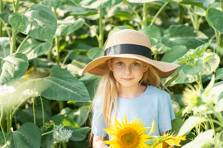 Beautiful little girl in sunflowers, a Person Photo by Olena Rudo
