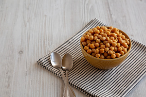 Organic Raw Canned Chickpeas in a Bowl, side view. Copy space., a Food & Drink Photo by LiudmylaChuhunova