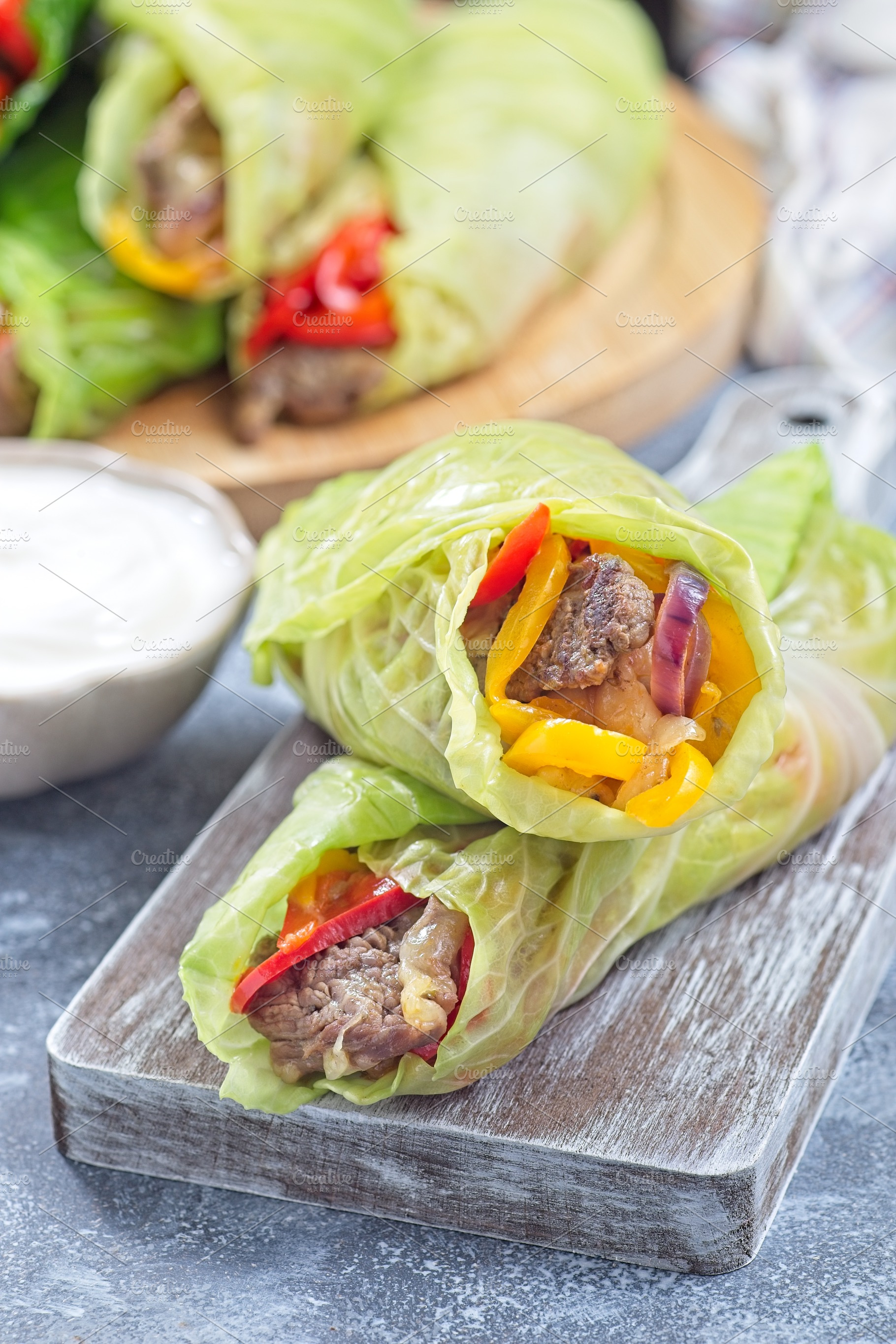 Beef and vegetable cabbage leaves wraps, served with plain yogurt, vertical, a Food & Drink Photo by iuliia_n