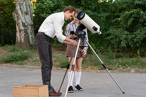 Teacher adjusting telescope, a School & Education Photo by Elena Vagengeim