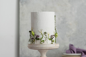 White wedding cake with lillac and green flowers