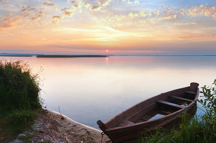 Sunset with old flooding boat on summer lake shore, a Nature Photo by YuriyB