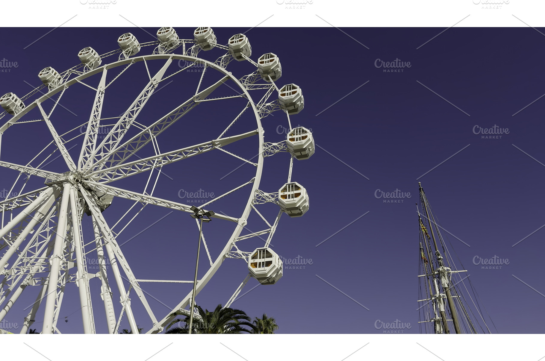 White ferris wheel rotating under, a Sports & Recreation Photo by Media Whale Stock