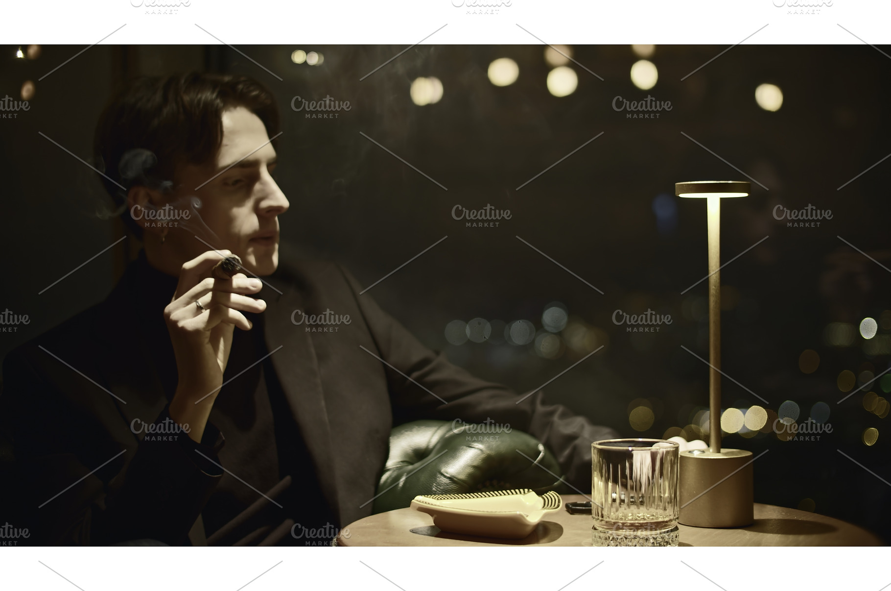 Young man elegantly smokes cigar, a Person Photo by Media Whale Stock