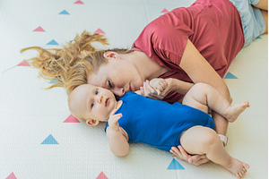 Mother and baby lying on a soft play, a Person Photo by Elizaveta Galitskaya