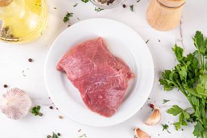 Raw meat, beef fillet, portioned piece on a cutting board with s, a Food & Drink Photo by Rimma