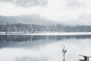 Tourist at winter mountain lake featuring active, activity, and adventure
