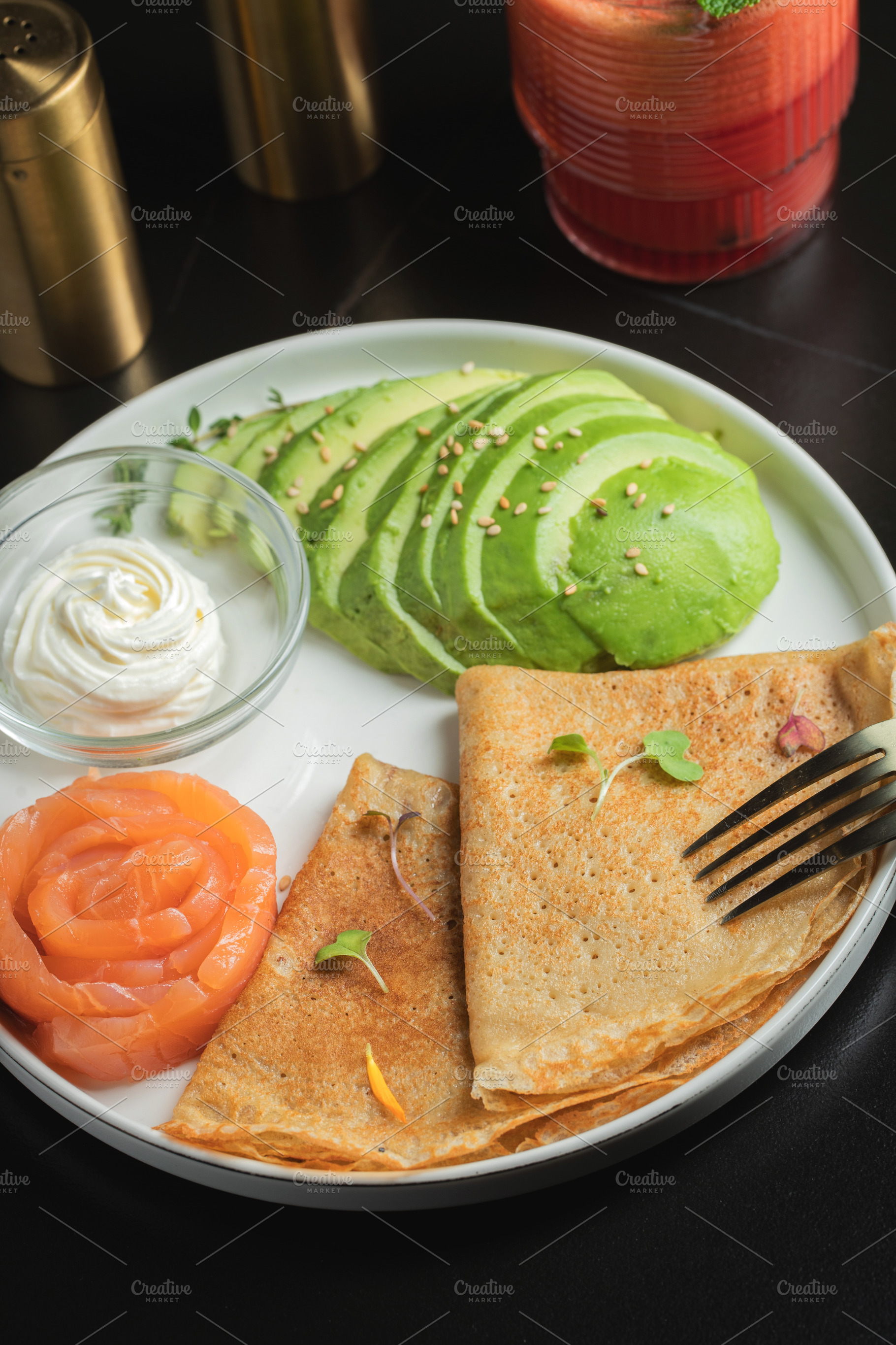 Roasted thin pancakes with smoked salmon and sauce, a Food & Drink Photo by Budarinphoto