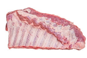 Fresh uncooked pork spareribs slab isolated on white background
