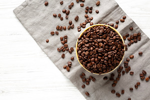 Organic Roasted Coffee Beans in a Bowl, top view., a Food & Drink Photo by LiudmylaChuhunova