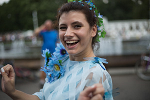 Girl in blue smiling teeth