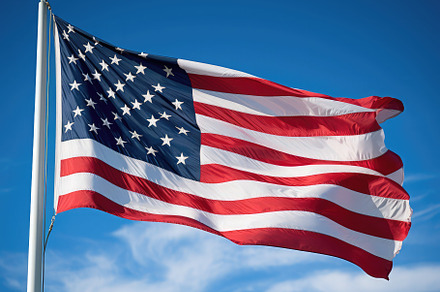 American flag waving proudly in the, a Photo by SaroStock