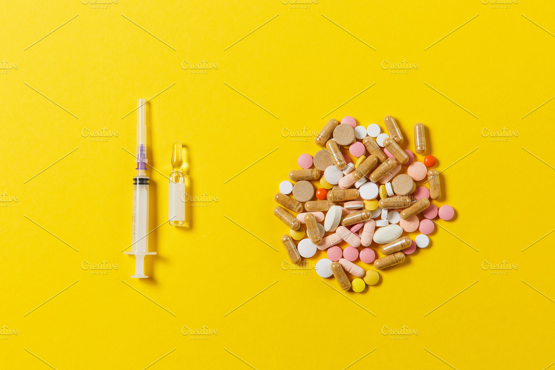 Medication colorful round tablets, capsule, pills arranged abstract on yellow background. Aspirin, ampoule, empty syringe needle. Health, treatment, choice, healthy lifestyle concept. Copy space., a Health & Medical Photo by ViDi Studio