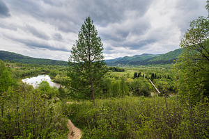 Spring picturesque river band view. Mountains scenery view behin