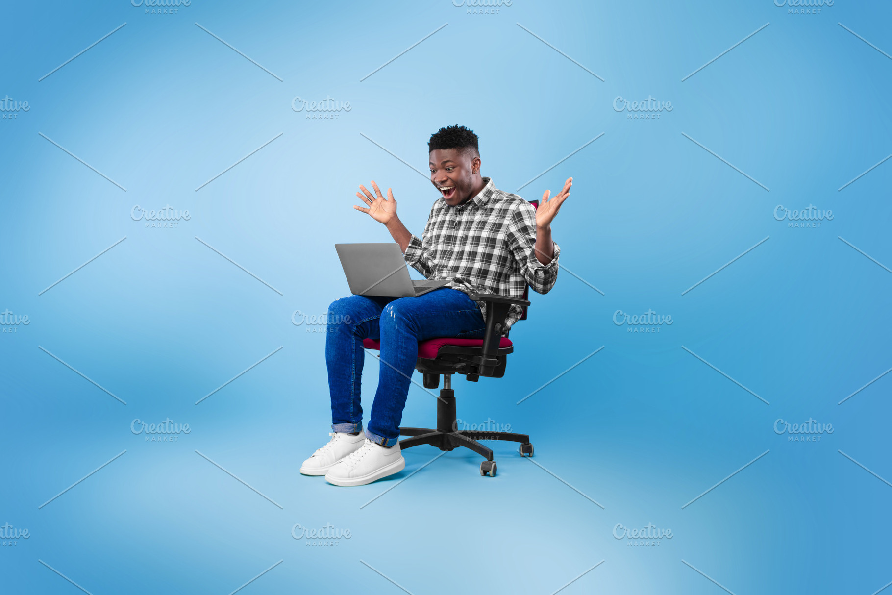 Excited young black man sitting on chair with laptop, celebrating success or ac, a Photo by Prostock-Studio
