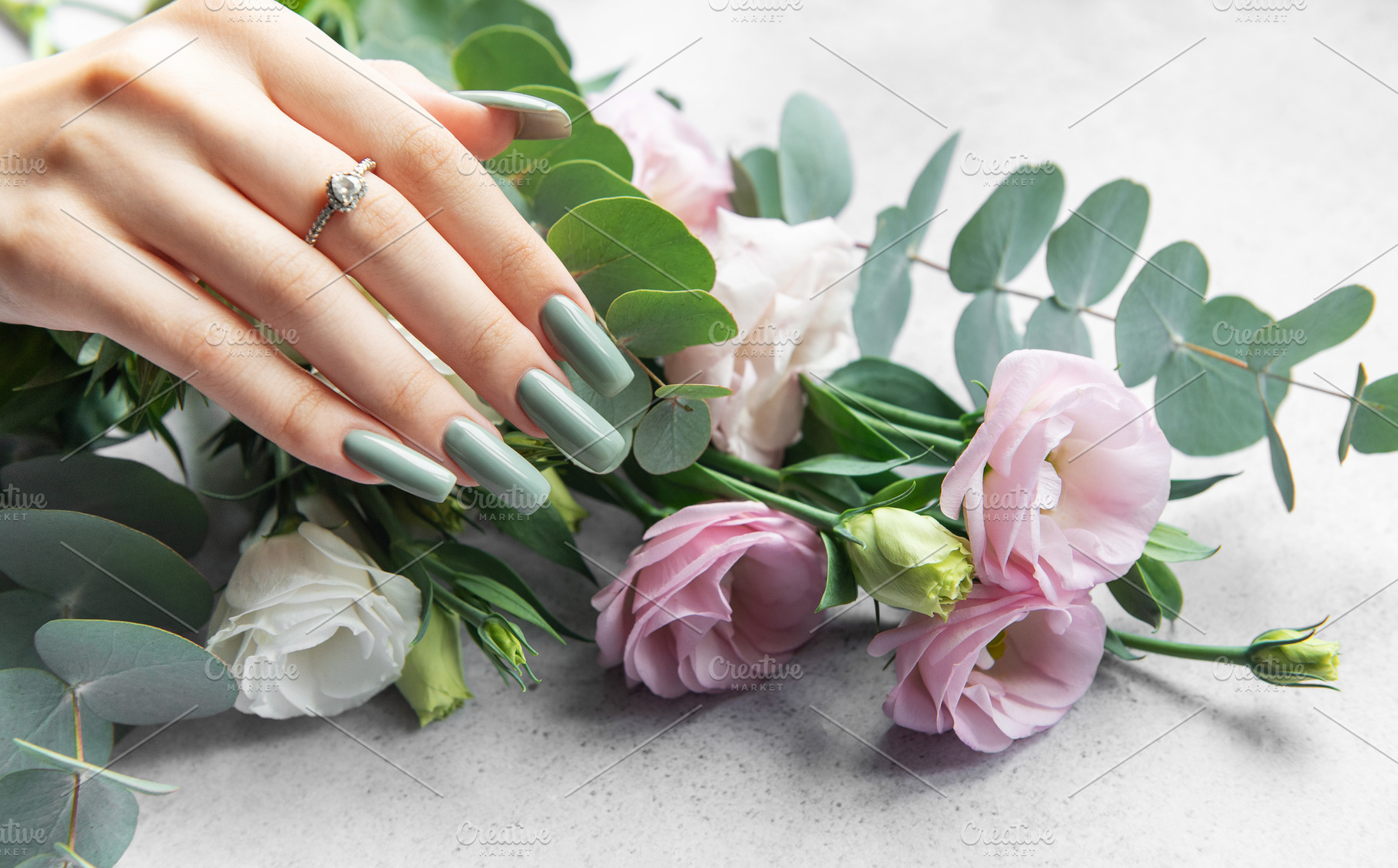 Elegant hand adorned with a ring showcasing stylish green nails, a Photo by Olena Rudo